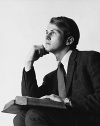 Poster print of a serious young man with a book on his lap
