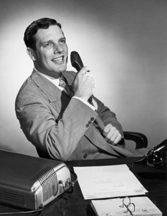 Businessman holding a telephone receiver and smiling poster print.