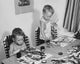 Poster print of two boys painting at a table, capturing childhood creativity and imagination.