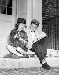 Schoolboy and schoolgirl sitting on a doorstep reading a book poster print.