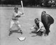 Baseball player swinging bat with catcher and umpire poster print