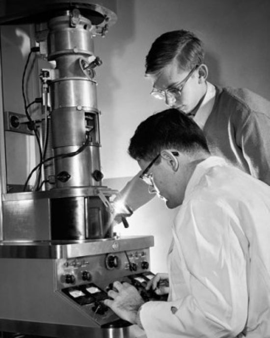 Poster print of two college students working in a laboratory