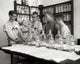 Poster of four boys conducting a chemistry experiment in a laboratory.