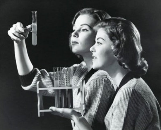 Poster print of two young women examining a solution in a test tube