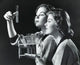 Poster print of two young women examining a solution in a test tube