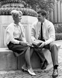 Poster print of two college students sitting on a ledge and smiling.