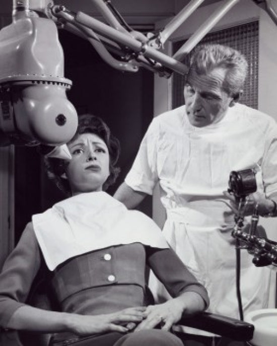 Female Patient Receiving Dental Treatment Poster Print, showcasing dental care moments.