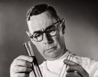 Close-up of a scientist comparing chemicals in test tubes poster print