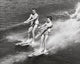Young couple waterskiing poster print capturing summer fun and adventure.