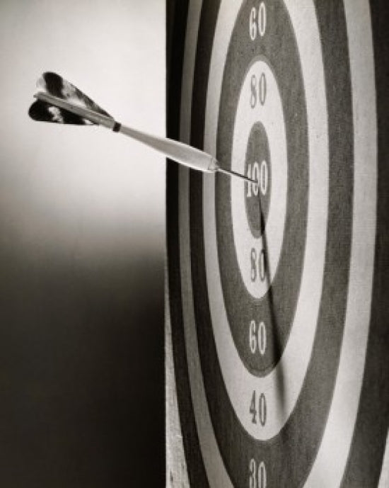 Close-up of a dart on a dartboard poster print