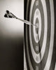 Close-up of a dart on a dartboard poster print