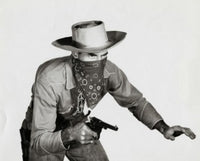Close-up of a cowboy holding a pistol poster print.