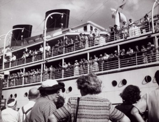 Group of people standing near a departing cruise ship poster print.
