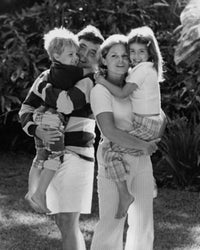 Close-up poster print of a mid-adult couple carrying their son and daughter.