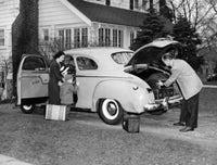 Family Adventure Loading Luggage Poster Print featuring a couple and children loading a car