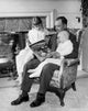 Father reading Alice in Wonderland to children poster print.