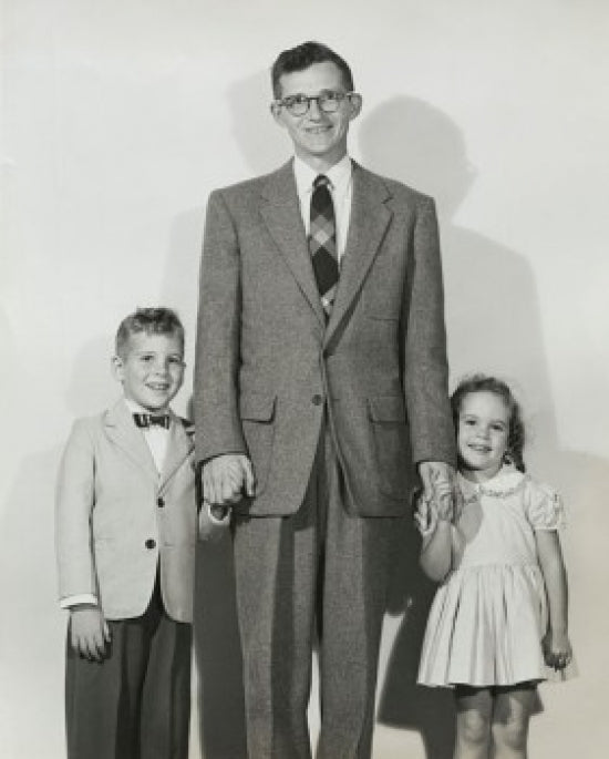 Portrait of a mid adult man standing with his son and daughter poster print.