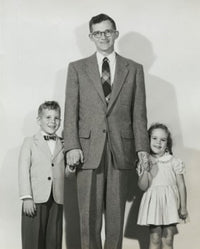 Portrait of a mid adult man standing with his son and daughter poster print.