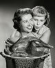 Mother holding a turkey with daughter hugging her - Thanksgiving poster print.