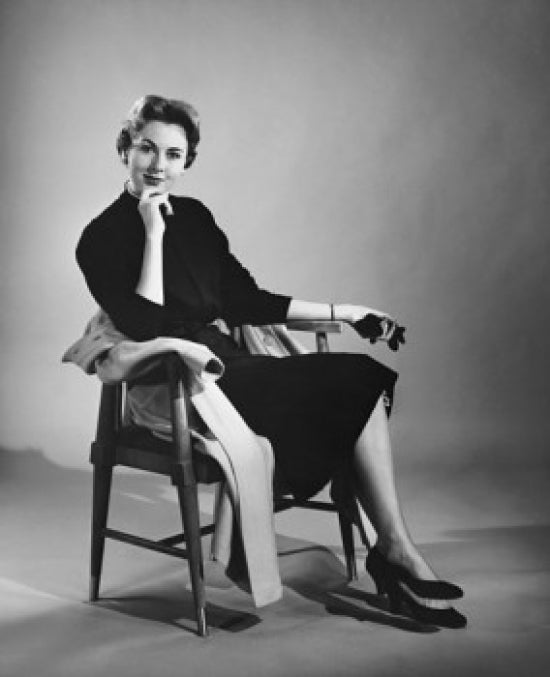 Portrait of a mid adult woman sitting in an armchair poster print.