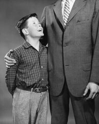 Close-up poster of a boy smiling with his father.