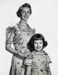 Portrait of a mother smiling with her daughter poster print.