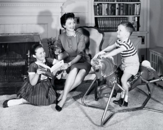 Poster print of a boy on a rocking horse with family.