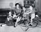 Poster print of a boy on a rocking horse with family.
