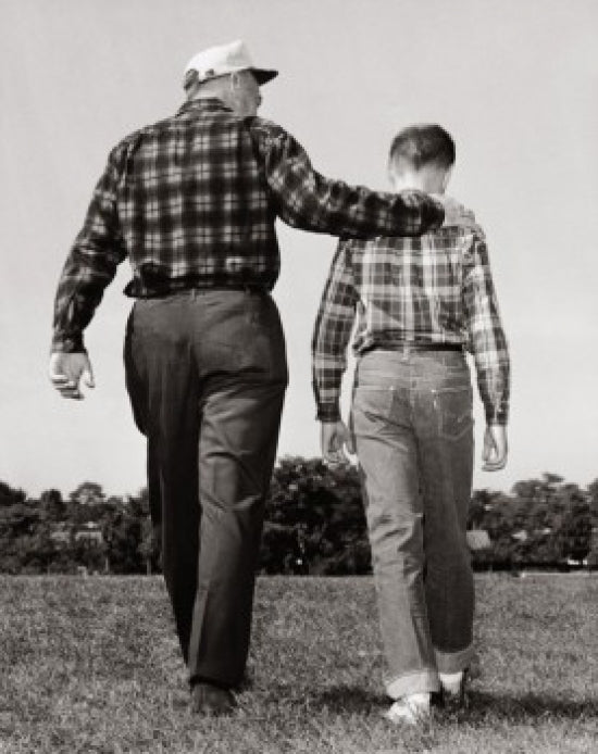 Grandfather and grandson walking in a park poster print