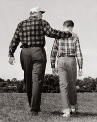 Grandfather and grandson walking in a park poster print