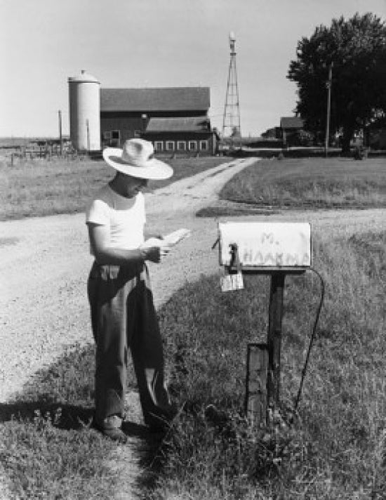 Side profile of a man reading mail in front of a mailbox in Randolph, Wisconsin, USA poster print.