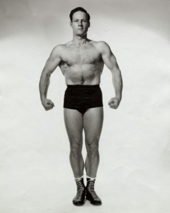 Young man flexing his muscles poster print showcasing strength and motivation.