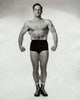 Young man flexing his muscles poster print showcasing strength and motivation.