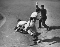 Dynamic baseball scene featuring two players and an umpire on the field.
