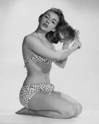 Portrait of a young woman combing her hair poster print