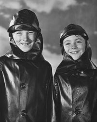 Two boys wearing raincoats and smiling poster print