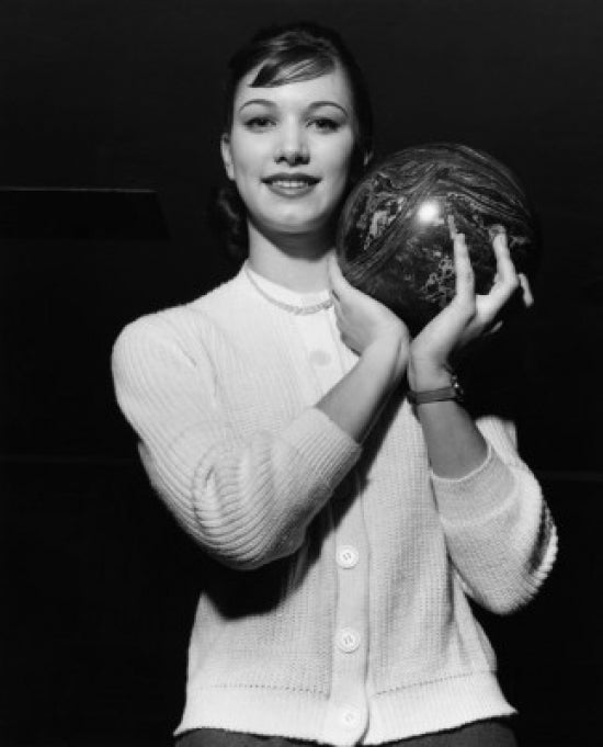 Young adult woman holding a bowling ball poster print