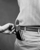 Close-up of a hand taking a wallet from a man's back pocket