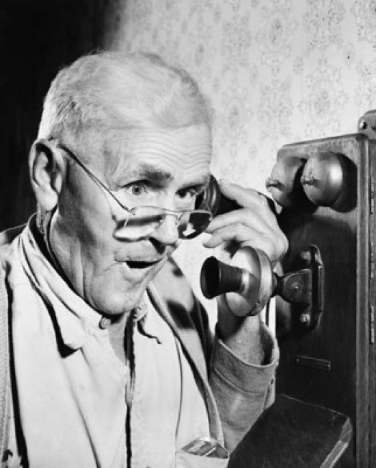 Close-up poster print of a senior man talking on the telephone.