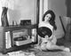 Young woman smiling while looking at a record poster print