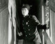 Policeman holding a nightstick and standing on staircase poster print.