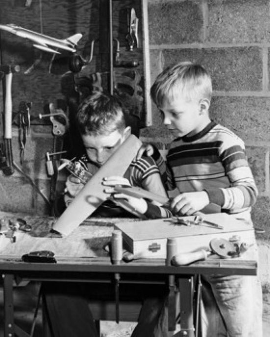Boy making a model airplane poster print, perfect for children's rooms.
