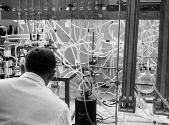 Researcher working with experimental apparatus poster print