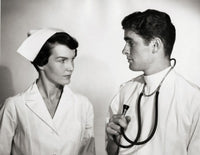 Doctor and Nurse Interaction Poster Print showcasing compassion in healthcare.