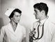 Doctor and Nurse Interaction Poster Print showcasing compassion in healthcare.