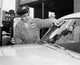 Gas station attendant cleaning the windshield of a car poster print.