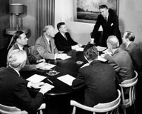 Poster print of a businessman giving a presentation in a meeting.