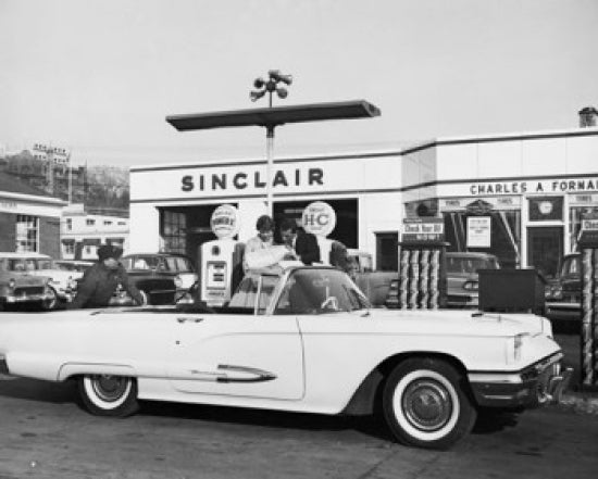 Poster print of a man refueling a car at a gas station.