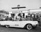 Poster print of a man refueling a car at a gas station.