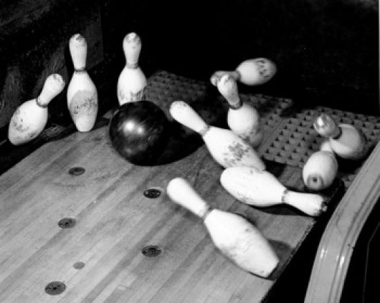 High angle view of a bowling ball knocking down bowling pins poster print